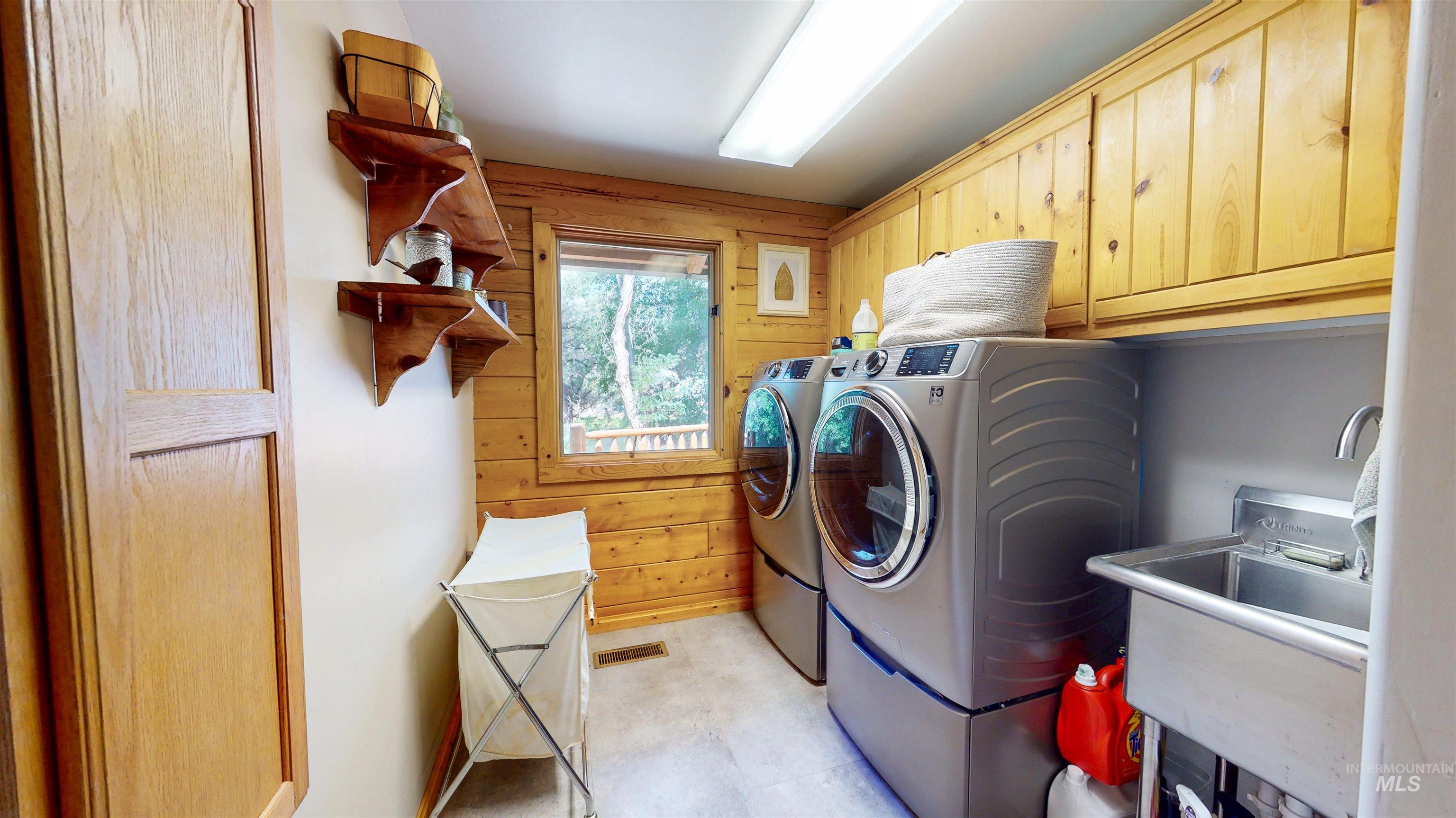 1314 River Road Buhl, ID 83316 - Photo 20 of 45 Washroom with cabinet space, washing machine and dryer, and wood walls