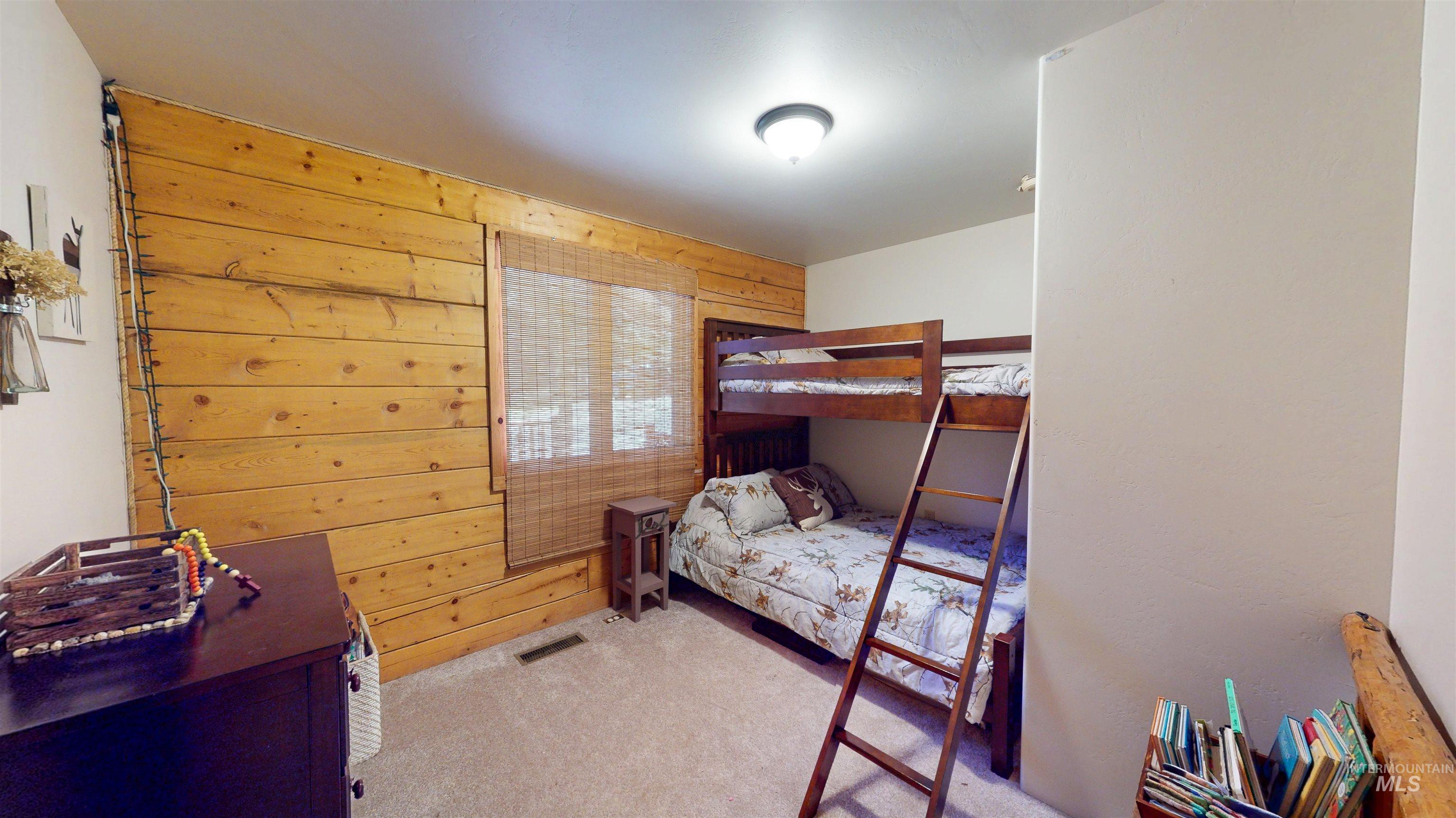 1314 River Road Buhl, ID 83316 - Photo 26 of 45 Carpeted bedroom featuring wooden walls