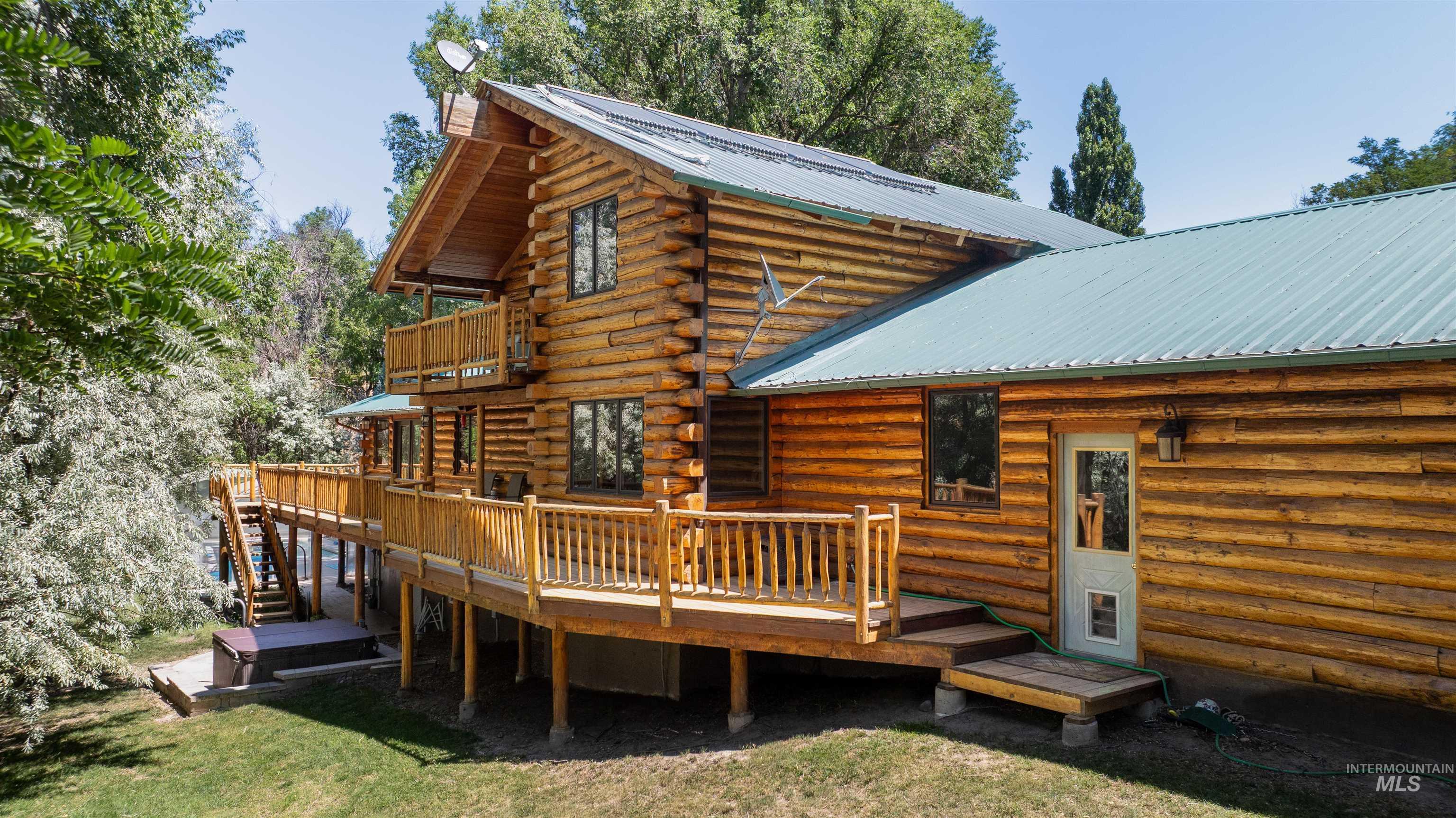 1314 River Road Buhl, ID 83316 - Photo 3 of 45 Rear view of house featuring a balcony, a metal roof, log exterior, and a deck