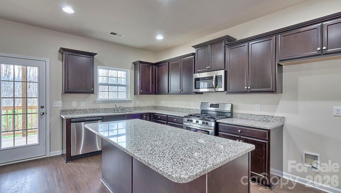109 Piney Wds Road Fletcher, NC 28732 - Photo 10 of 28 a kitchen with granite countertop a sink a counter space appliances and cabinets