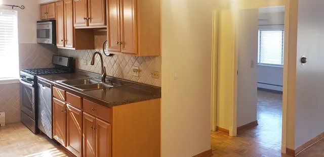 a kitchen with stainless steel appliances granite countertop a sink stove and cabinets