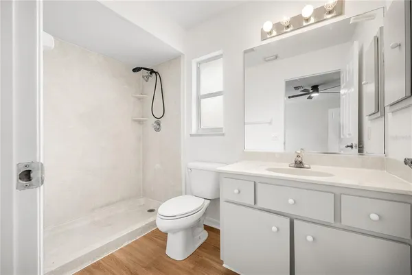 a bathroom with a sink a toilet and shower