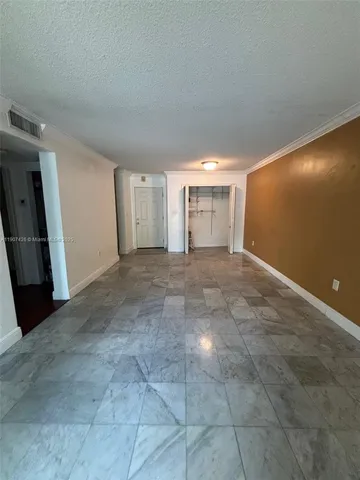 a view of a livingroom with an empty space and a window