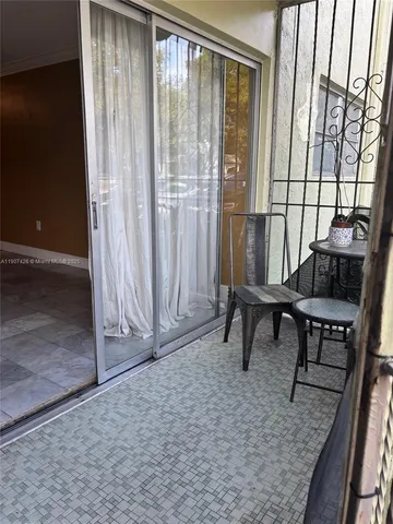 a view of a room with furniture and window