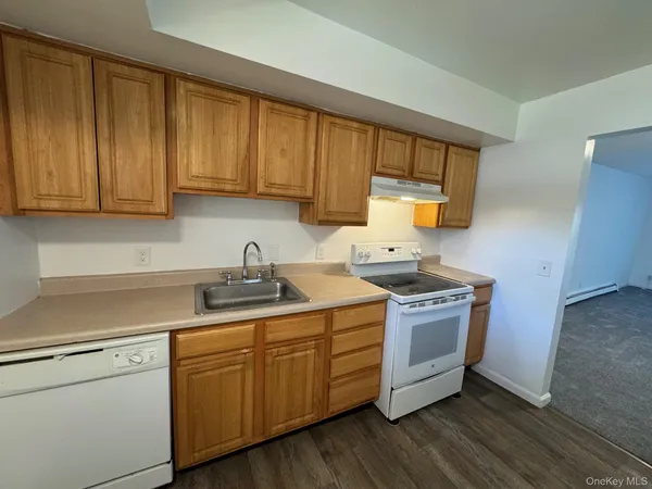 a view of a refrigerator in kitchen and wooden floor