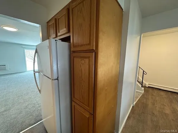 a view of a livingroom with an empty space and a window
