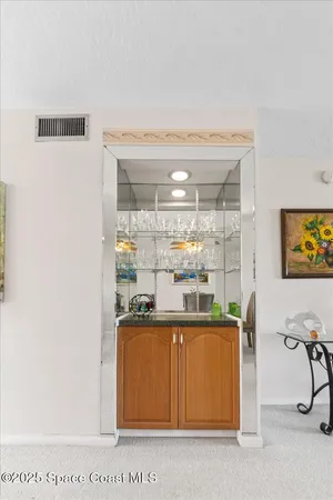 a room with stainless steel appliances wooden floor and view kitchen