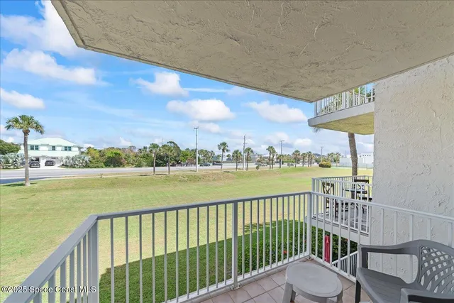 a view of a balcony with lake view and wooden floor