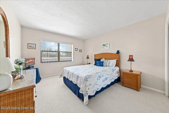 a bedroom with a bed table and window