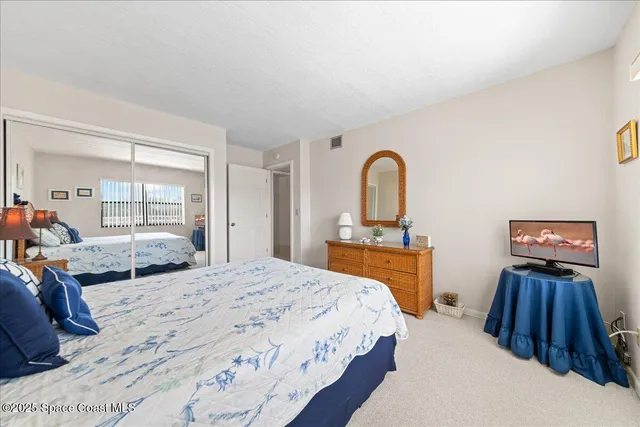 a bedroom with a large bed and a dresser