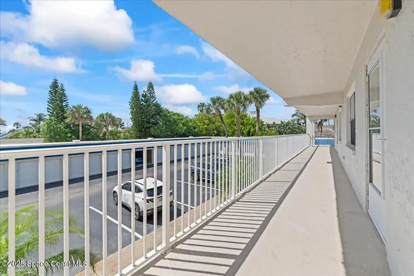 a view of balcony with wooden floor and fence