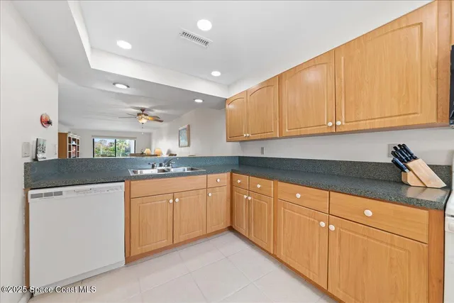 a kitchen with granite countertop a sink and cabinets