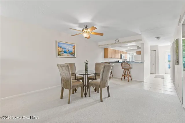 a view of a dining room with furniture and a chandelier