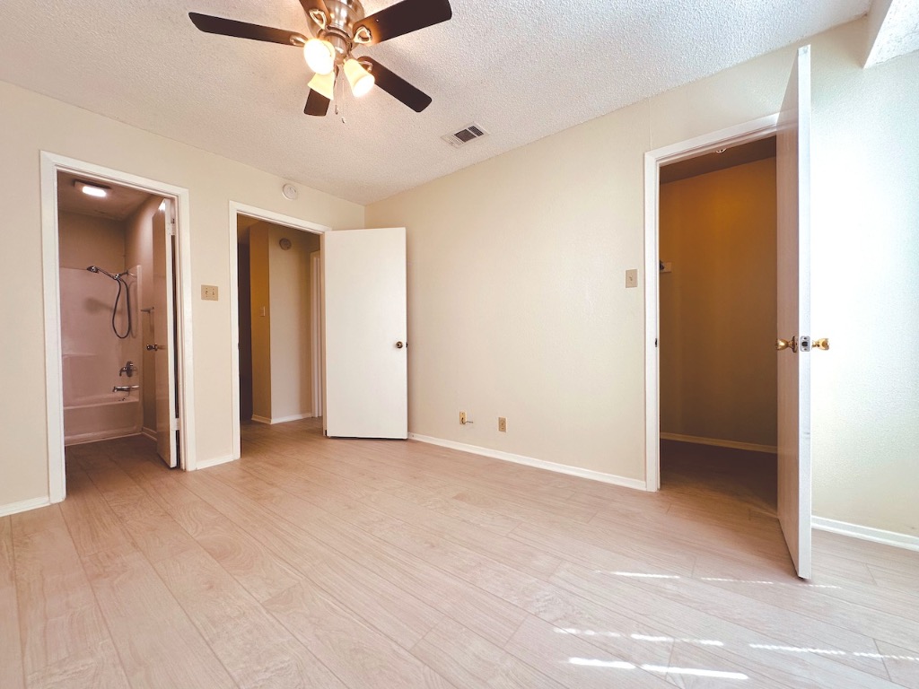 2004 Kirksey Drive, Unit D Austin, TX 78741 - Photo 11 of 20 a view of an empty room with a ceiling fan