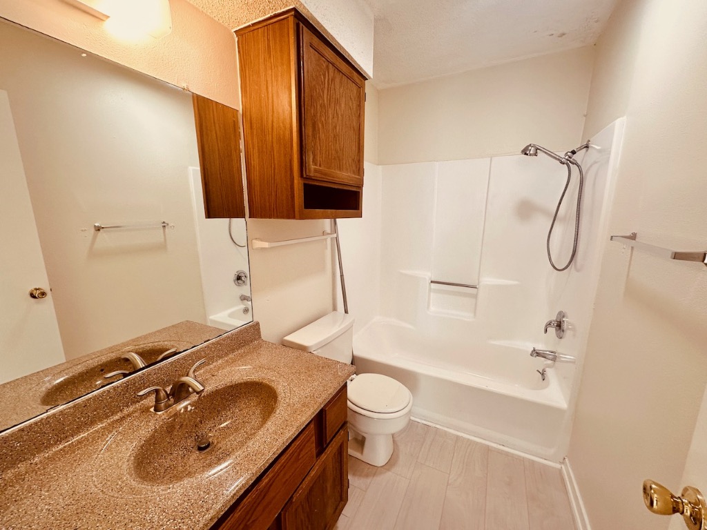 2004 Kirksey Drive, Unit D Austin, TX 78741 - Photo 13 of 20 a bathroom with a sink toilet a mirror and shower