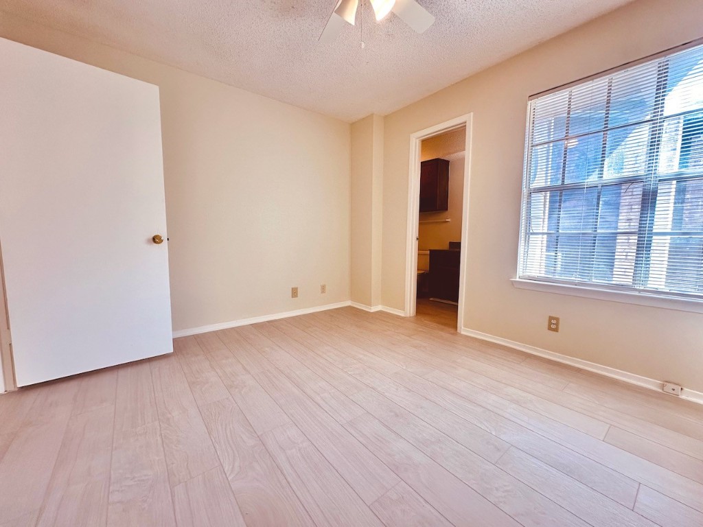 2004 Kirksey Drive, Unit D Austin, TX 78741 - Photo 15 of 20 a view of an empty room with wooden floor and a window
