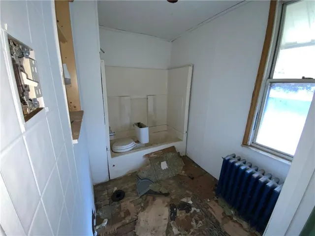 a bedroom with a bed and a mirror