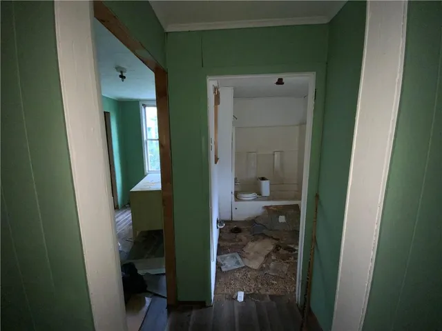 a view of a hallway with wooden floor and stairs