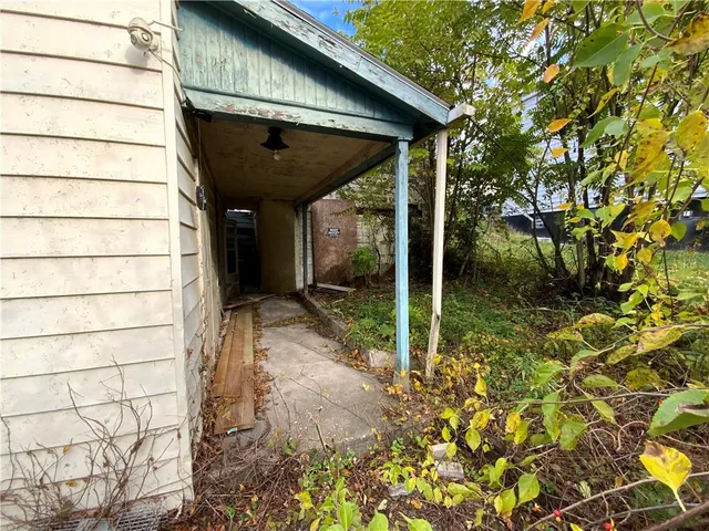 a view of a house with a small yard and wooden floor