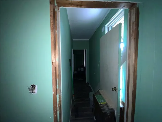 a view of hallway with wooden floor