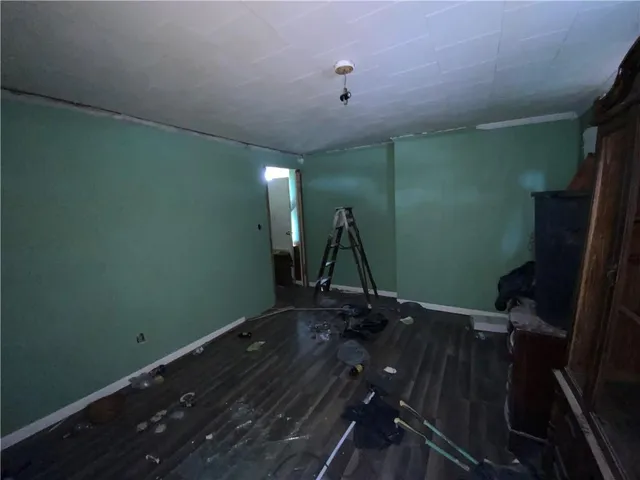 a room with hard wood floors and a large window