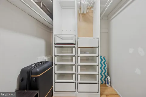 a view of walk in closet with empty racks
