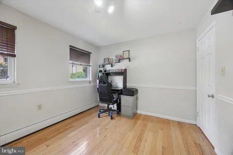 a workspace with wooden floor and a window