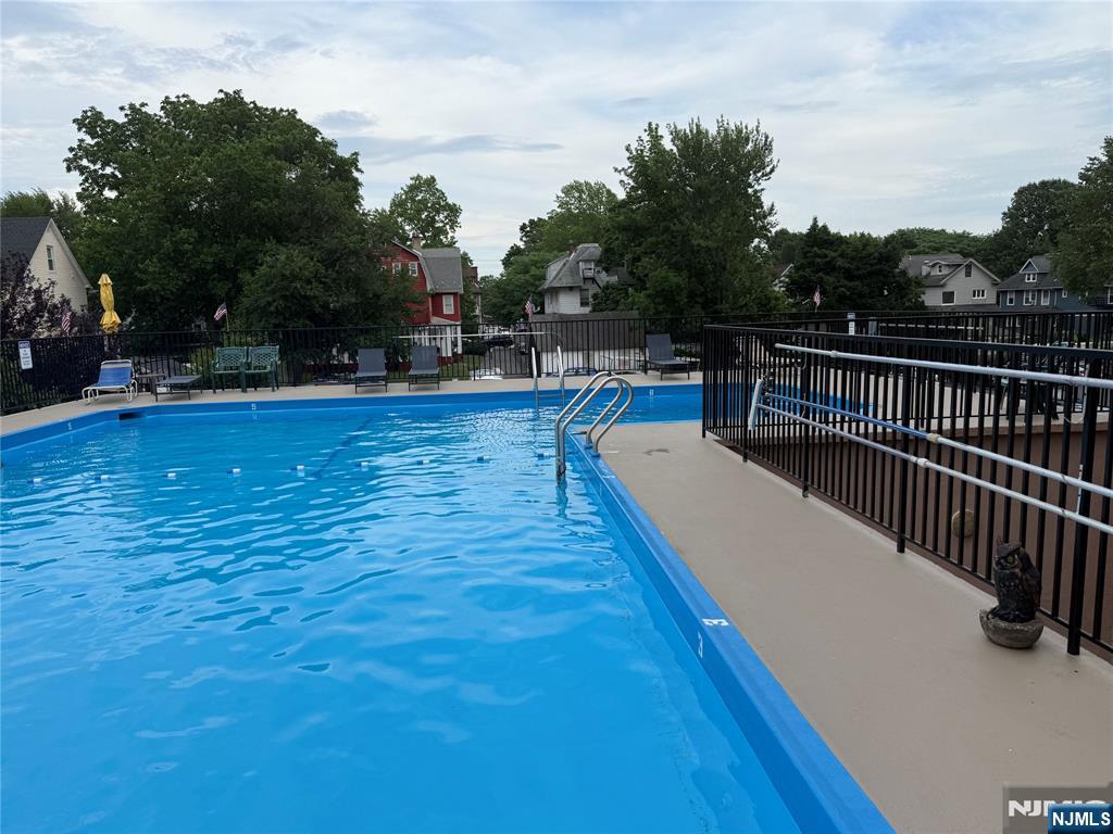 265 Main Street, Unit 702 Ridgefield Park, NJ 07660 - Photo 10 of 20 a view of a swimming pool with a lounge chair
