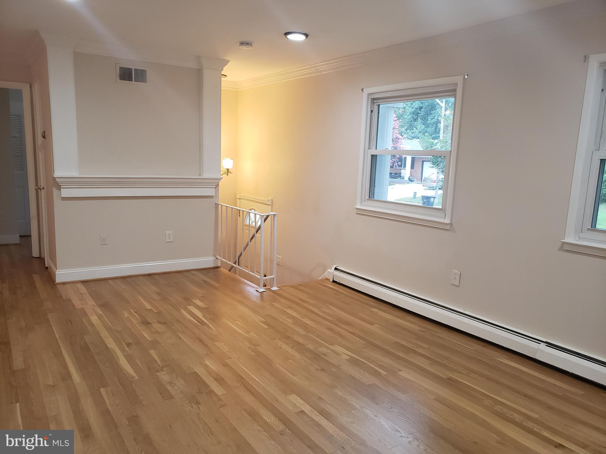 13350 Kerrydale Road Woodbridge, VA 22193 - Photo 2 of 10 an empty room with wooden floor and windows