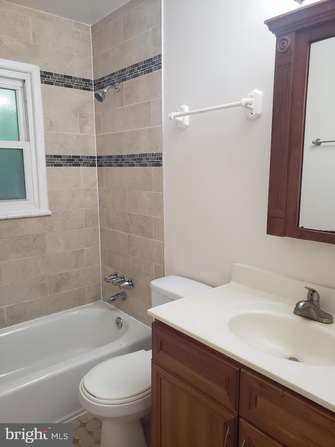 13350 Kerrydale Road Woodbridge, VA 22193 - Photo 3 of 10 a bathroom with a sink toilet vanity and shower