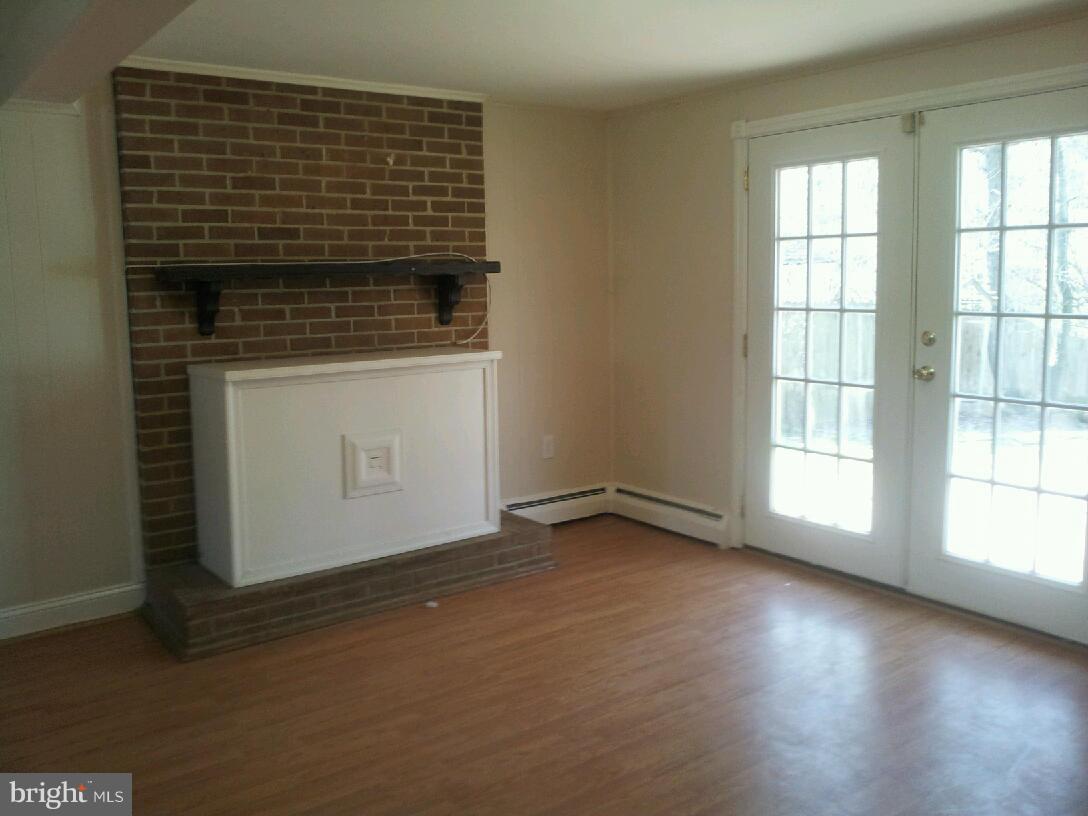 13350 Kerrydale Road Woodbridge, VA 22193 - Photo 7 of 10 an empty room with wooden floor and windows