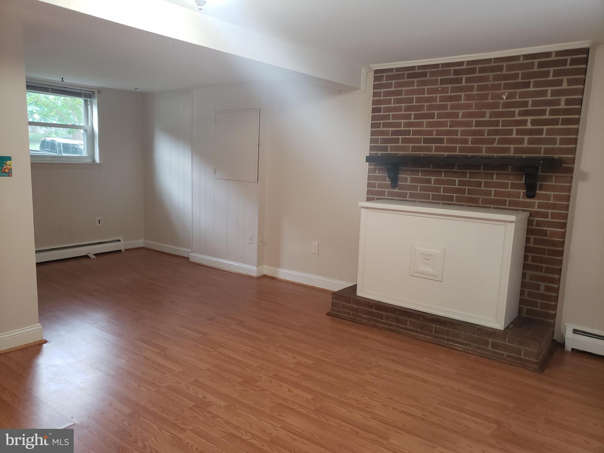 13350 Kerrydale Road Woodbridge, VA 22193 - Photo 8 of 10 an empty room with wooden floor and windows