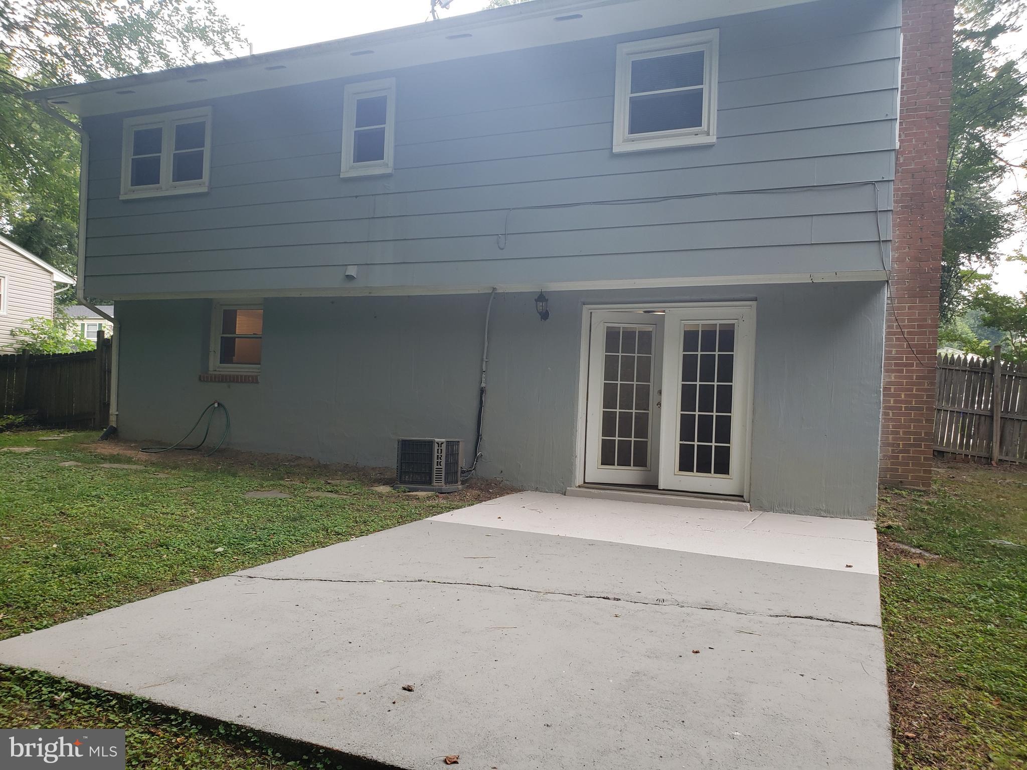 13350 Kerrydale Road Woodbridge, VA 22193 - Photo 9 of 10 a front view of a house with a garden and yard
