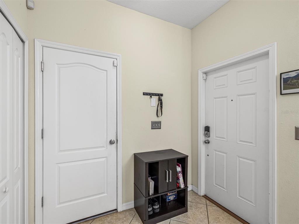 9588 Trumpet Vine Loop Trinity, FL 34655 - Photo 13 of 49 a room with a fireplace and mirror