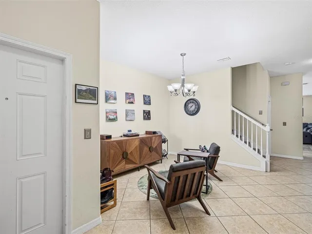 a view of a dining room with furniture and chandelier