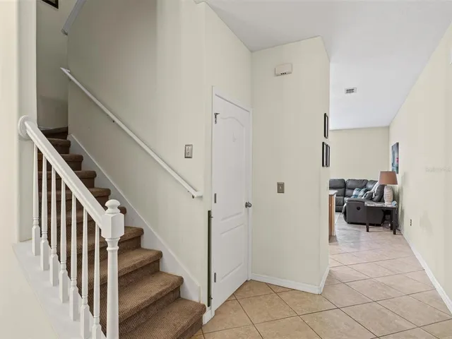 a view of a livingroom with a dinning area hardwood floor and staircase