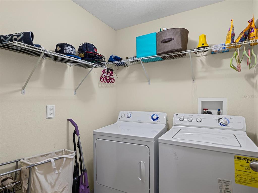 9588 Trumpet Vine Loop Trinity, FL 34655 - Photo 18 of 49 a utility room with dryer and washer