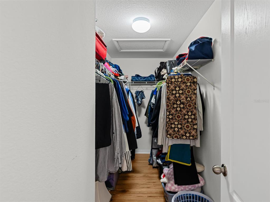 9588 Trumpet Vine Loop Trinity, FL 34655 - Photo 22 of 49 a view of walk in closet with clothes and shoes