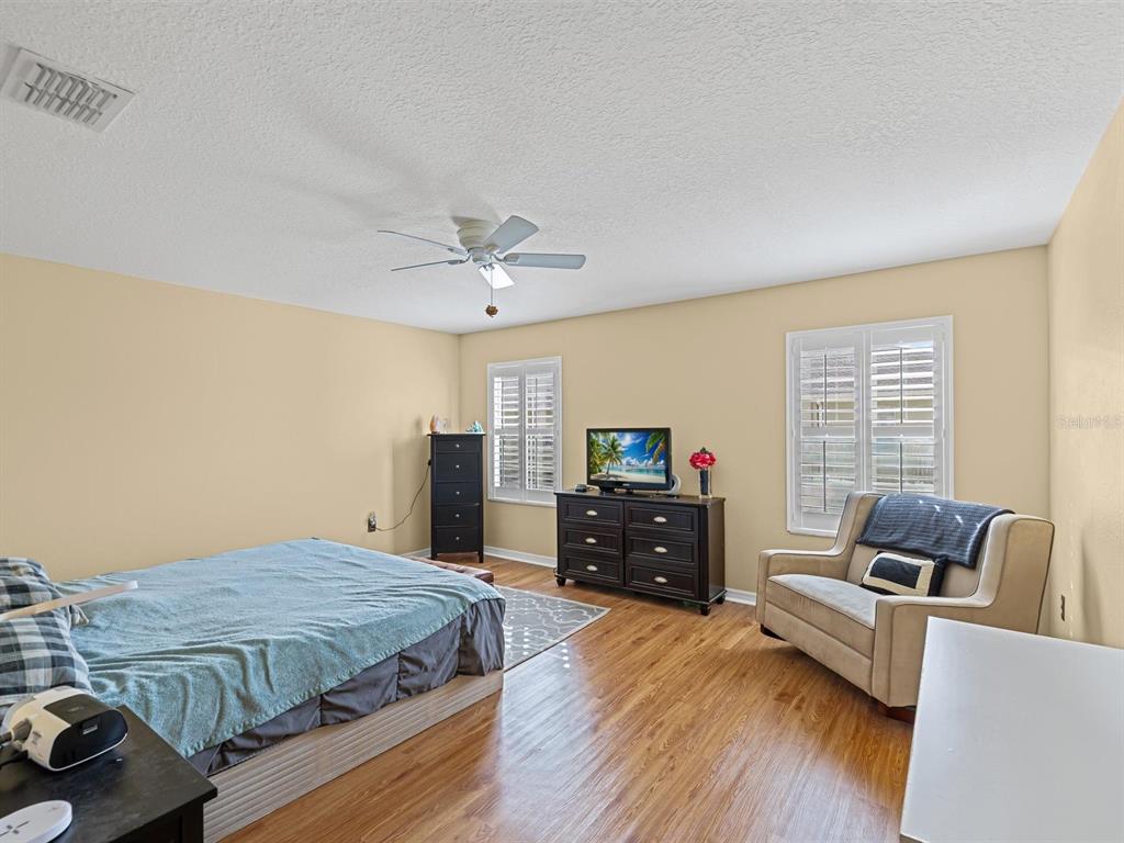 9588 Trumpet Vine Loop Trinity, FL 34655 - Photo 23 of 49 a bedroom with a bed and furniture