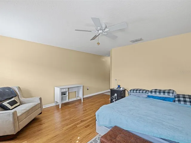 a bedroom with furniture and wooden floor