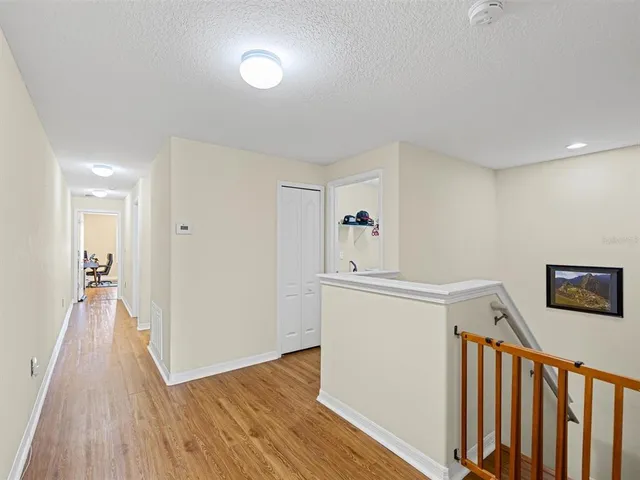 a view of hallway with wooden floor