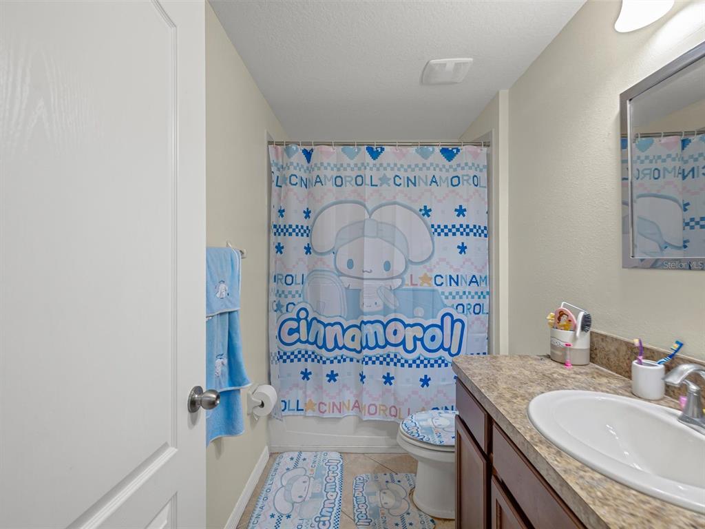 9588 Trumpet Vine Loop Trinity, FL 34655 - Photo 26 of 49 a bathroom with a sink and a mirror