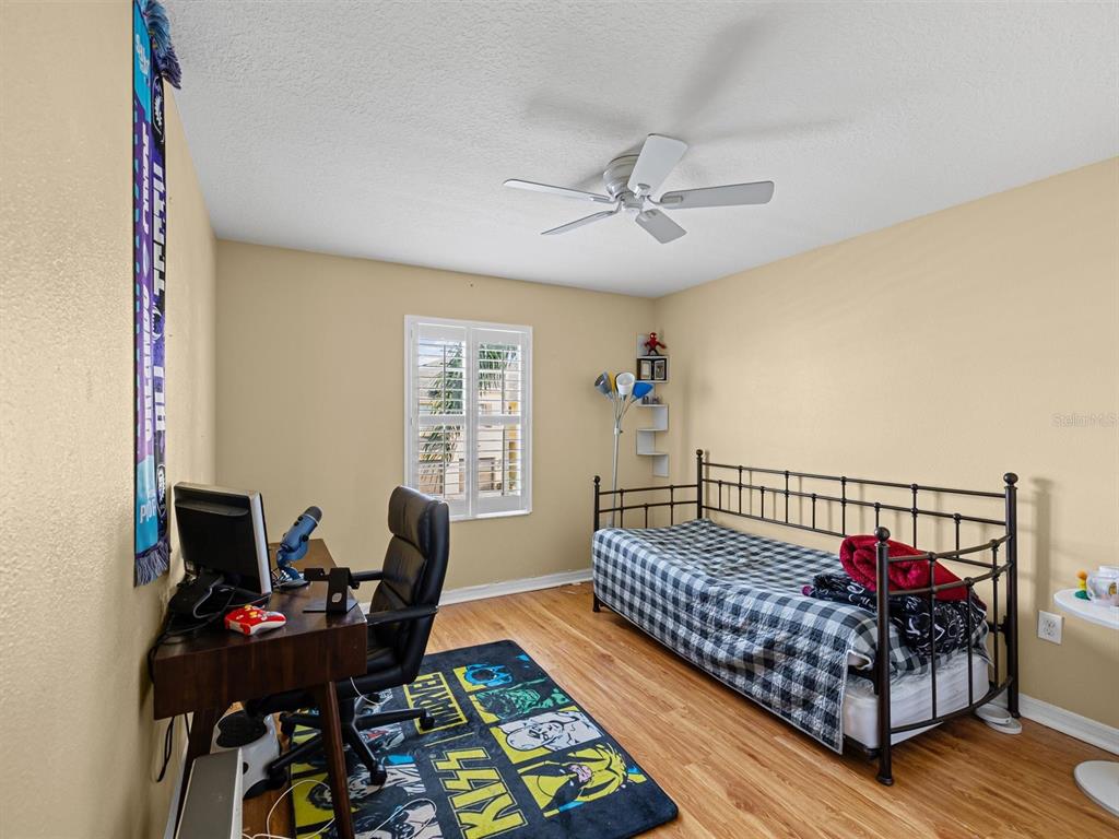 9588 Trumpet Vine Loop Trinity, FL 34655 - Photo 29 of 49 a bedroom with furniture and a window