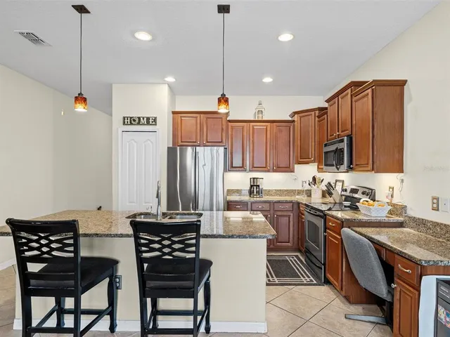 a kitchen with a table chairs stove and cabinets