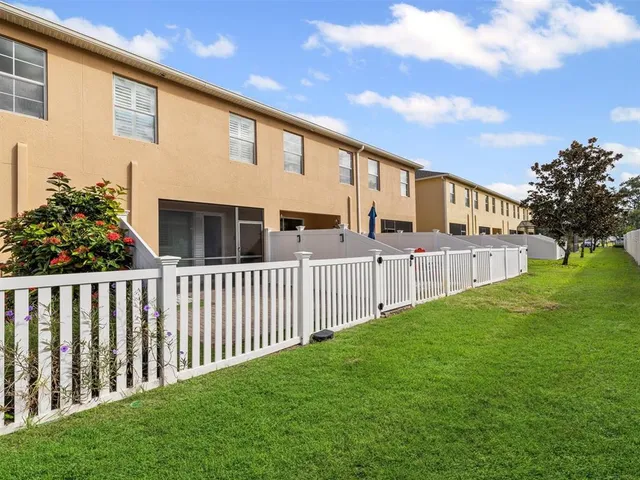 a front view of a house with a garden and parking