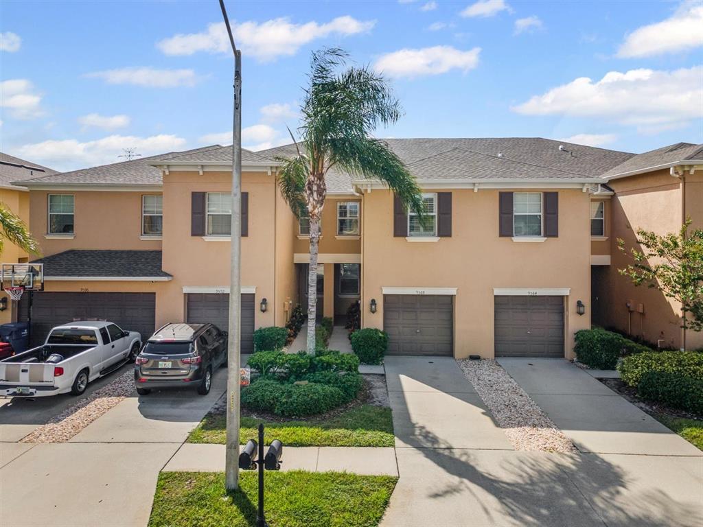 9588 Trumpet Vine Loop Trinity, FL 34655 - Photo 37 of 49 a front view of a house with a garden and parking