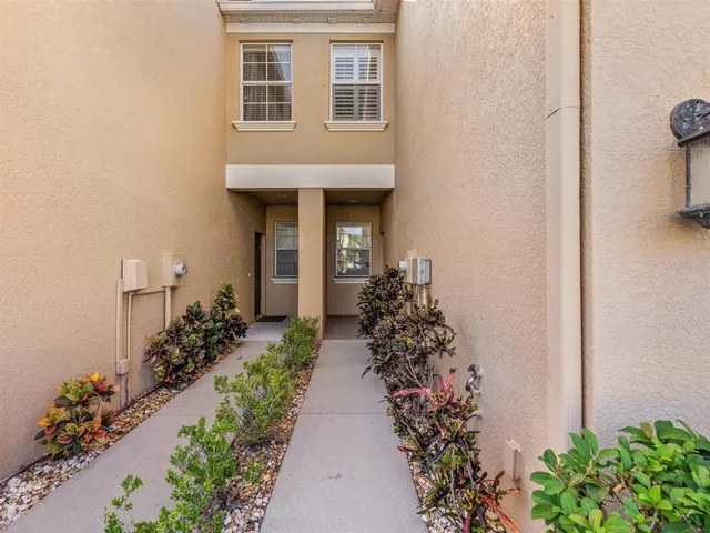 a view of a house with a yard and a street