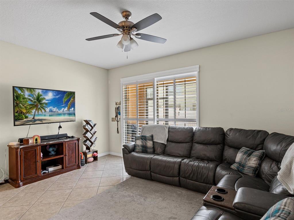 9588 Trumpet Vine Loop Trinity, FL 34655 - Photo 4 of 49 a living room with furniture and a flat screen tv