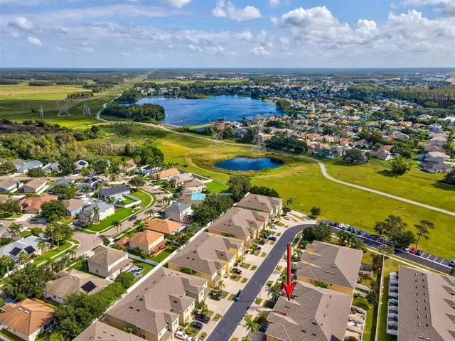 an aerial view of house with outdoor space and parking