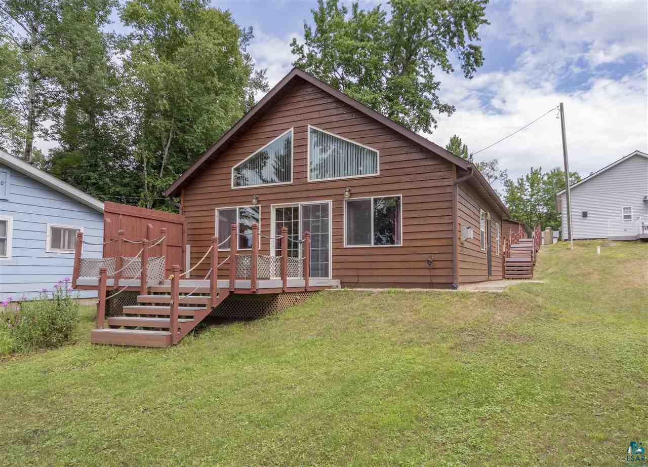 6190 East Lyman Lake Road South Range, WI 54874 - Photo 1 of 25 View of the home from the lake, with deck, windows, and gorgeous views.
